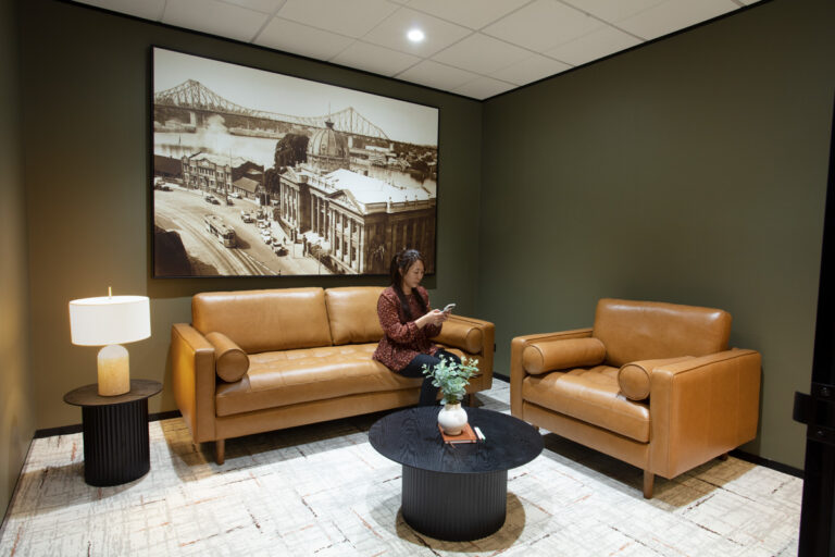 leather arm chairs in a meeting room with print on wall