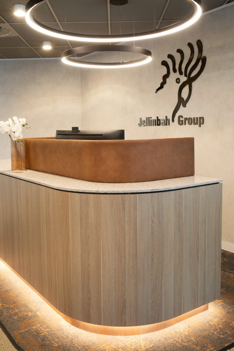 timber reception desk with signage that reads Jellinbah group