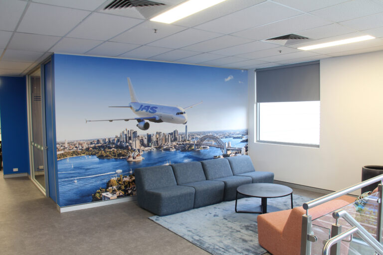 Reception area in an office with wall graphic of a plane