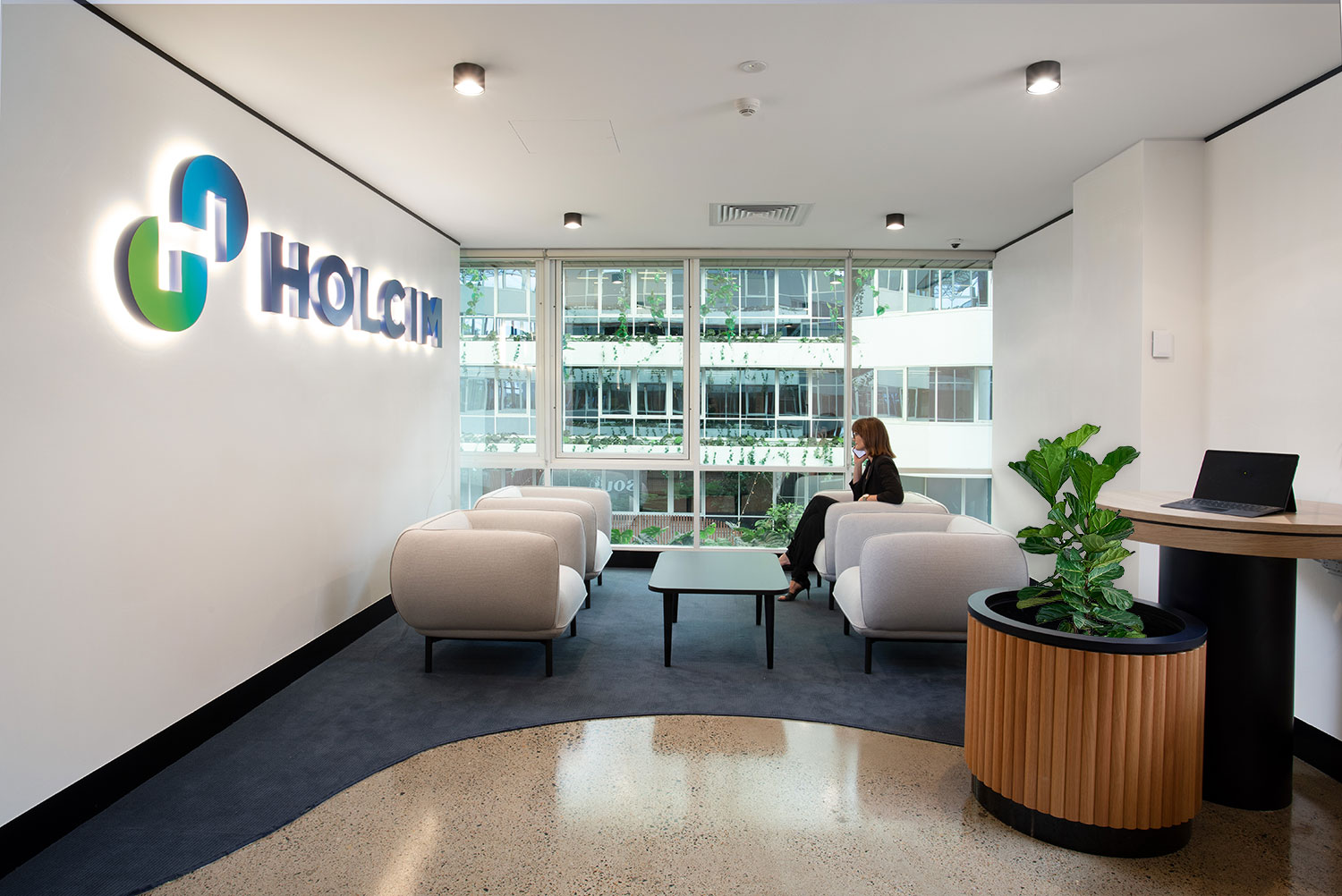 reception area in an office with the logo 'Holcim' on the wall