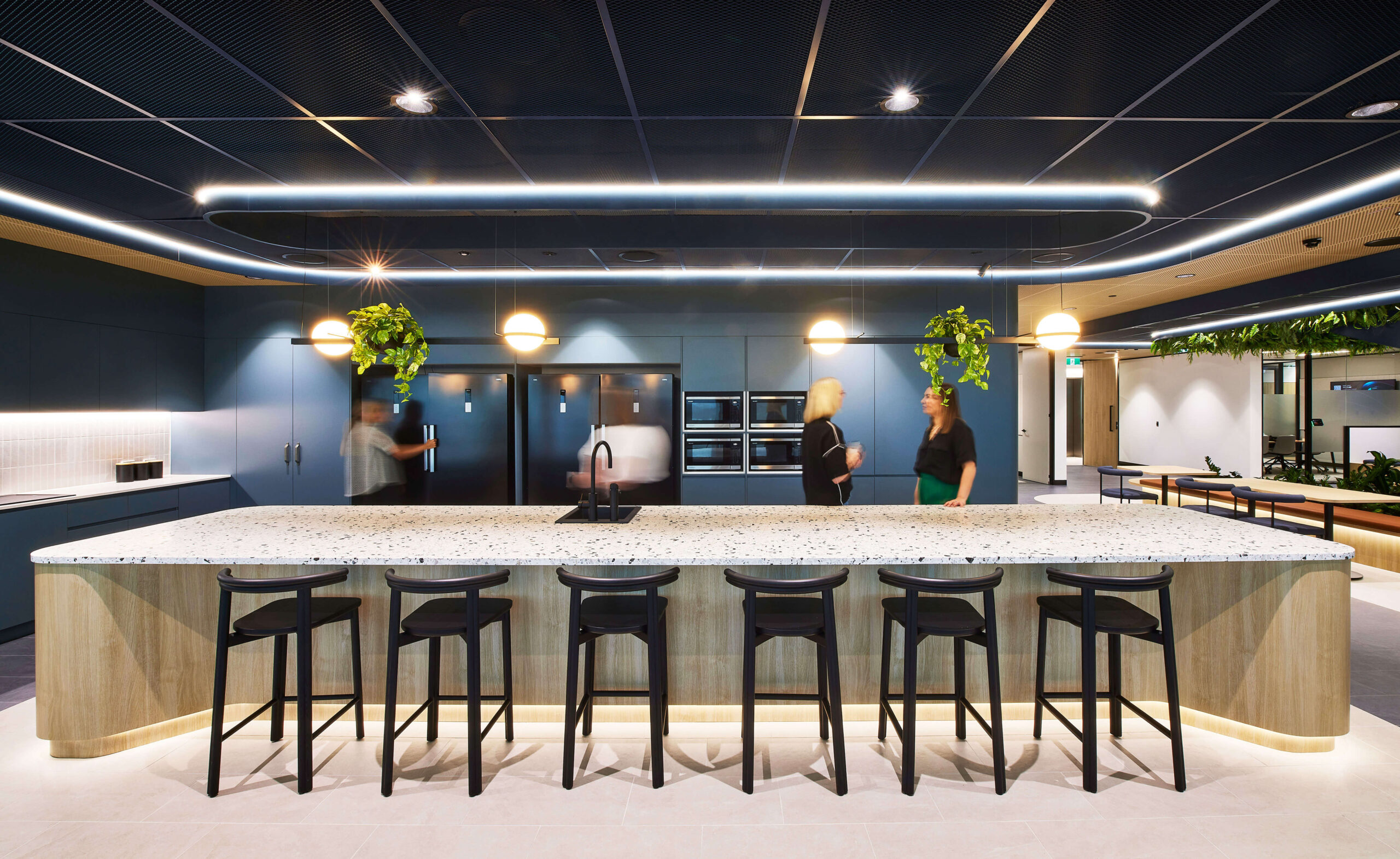 Modern Office suite open kitchen with island bench seating, with open dining tables